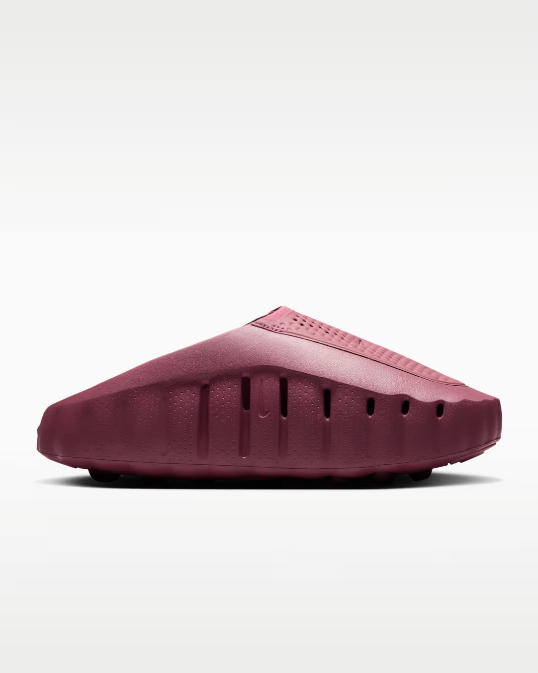 A single slip-on clog-style shoe in a deep burgundy or maroon color, shown from a side profile view against a clean white background.